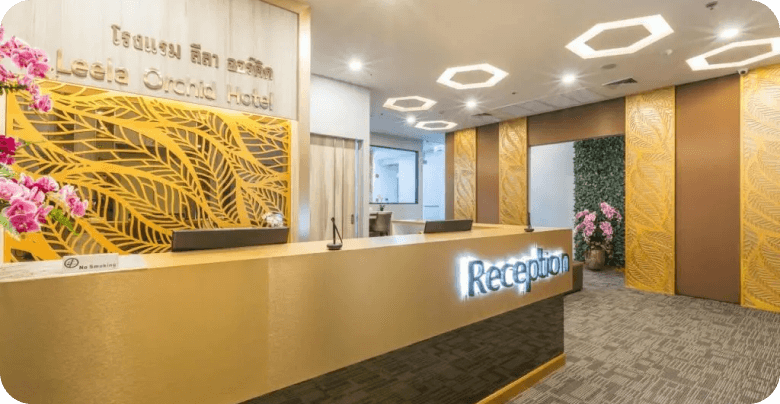 Curved desk, gold patterns, orchids, hexagonal lights.